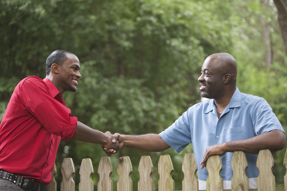 african-american-neighbors-greeting-each-other-over-fence-137924297-5a9863920e23d900370c683e